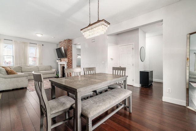 dining room featuring a fireplace and dark hardwood / wood-style floors