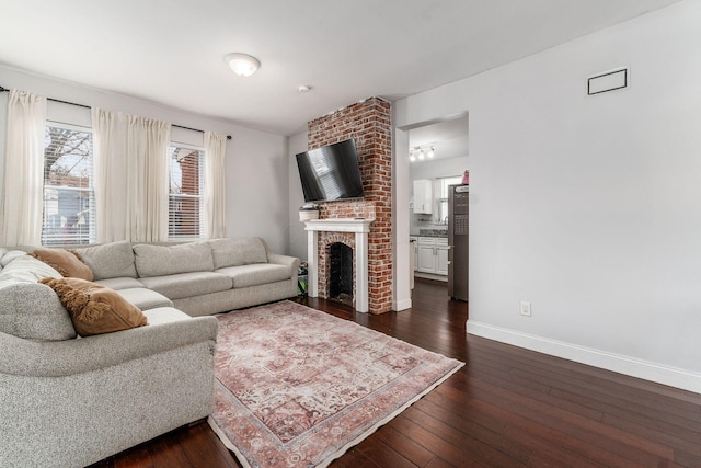 living room with a fireplace and dark hardwood / wood-style floors