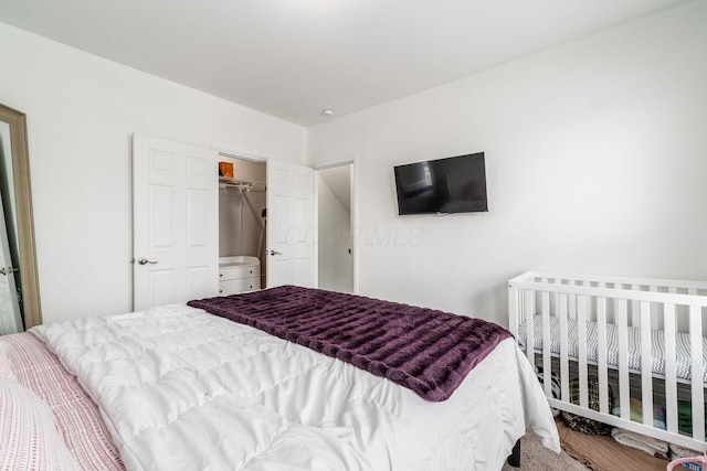 bedroom with a walk in closet and a closet