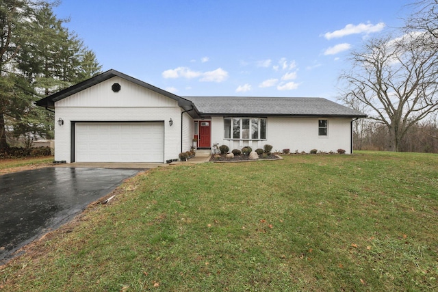 ranch-style home featuring a garage and a front lawn