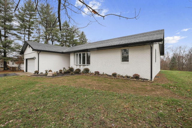 view of property exterior with a garage and a lawn