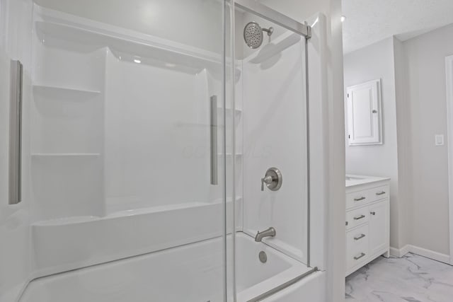 bathroom featuring vanity, combined bath / shower with glass door, and a textured ceiling