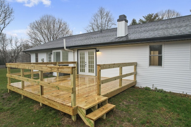 wooden terrace featuring a lawn and french doors