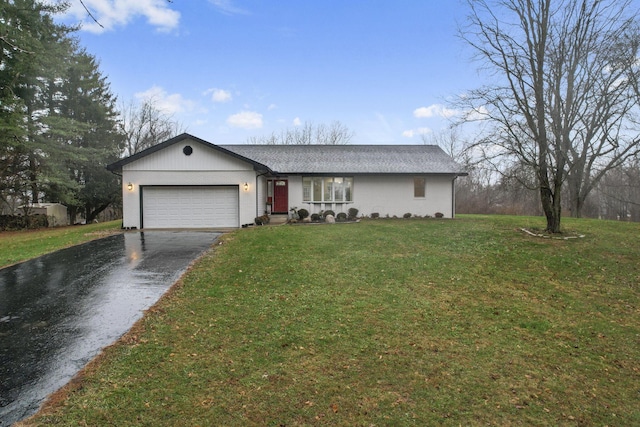 ranch-style home featuring a garage and a front lawn