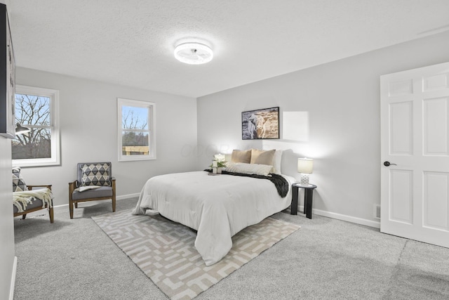 carpeted bedroom featuring a textured ceiling