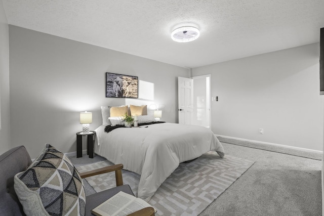 carpeted bedroom featuring a textured ceiling