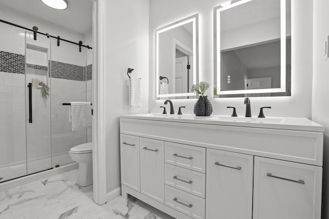 bathroom featuring toilet, vanity, and a shower with shower door