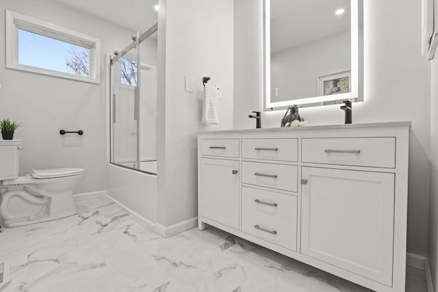 full bathroom with toilet, vanity, and bath / shower combo with glass door