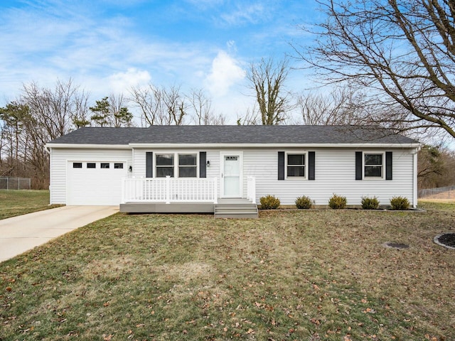 ranch-style house featuring a garage and a front lawn