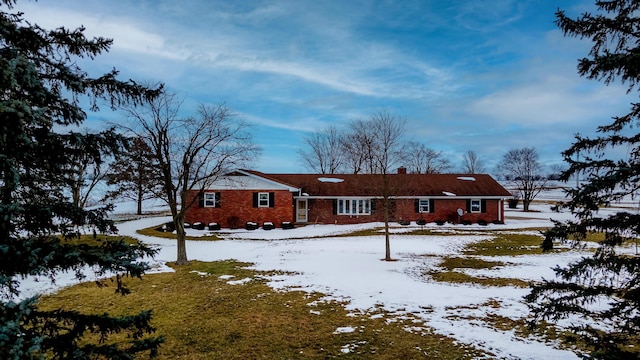 view of snow covered back of property