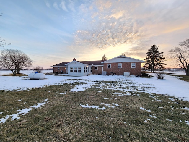 view of snow covered rear of property