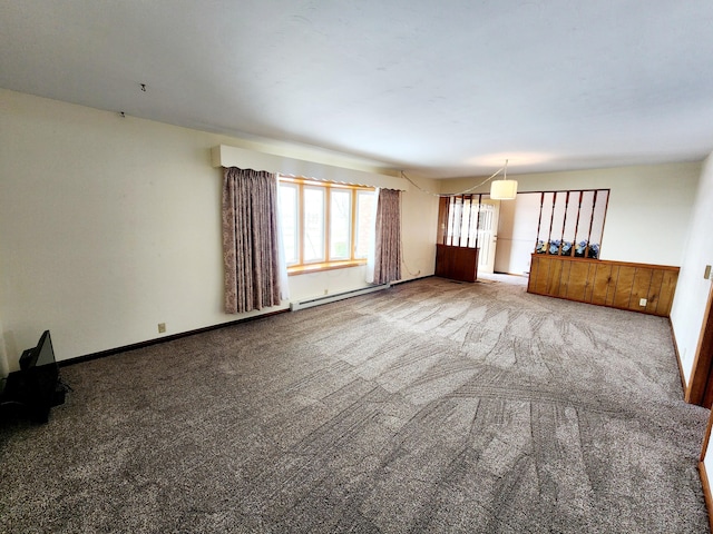 unfurnished living room featuring carpet flooring and baseboard heating