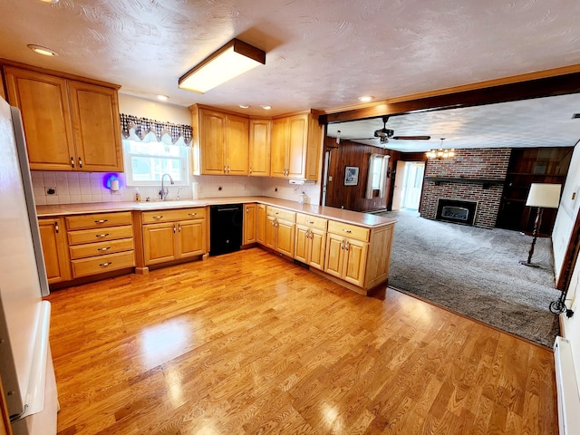 kitchen with dishwasher, decorative backsplash, a textured ceiling, and kitchen peninsula