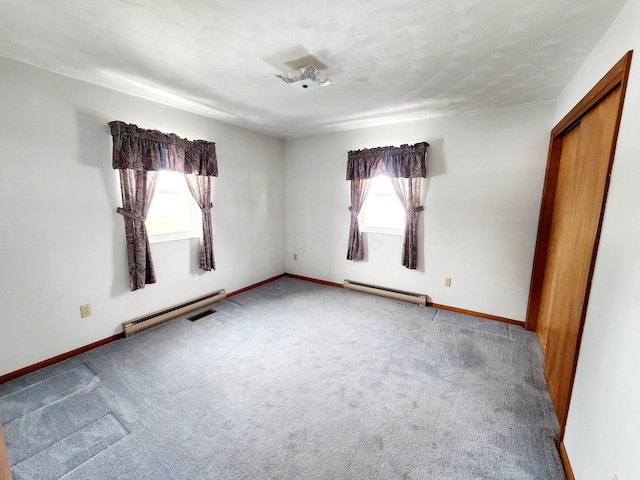 unfurnished bedroom with a baseboard radiator, carpet flooring, and a closet