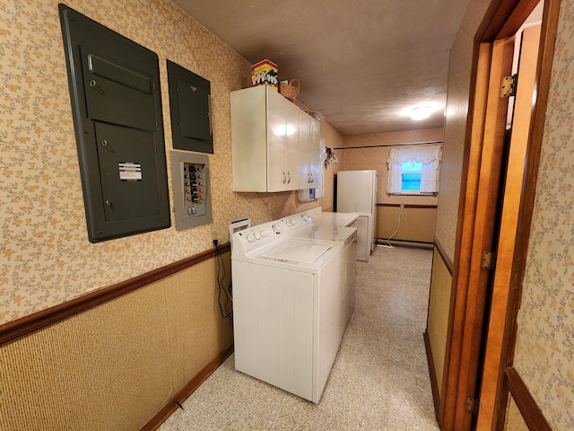 laundry area featuring washer / dryer, electric panel, cabinets, and a textured ceiling