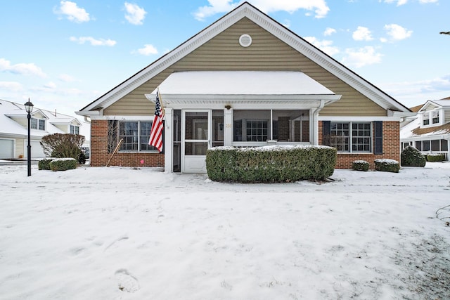 bungalow-style house featuring a sunroom