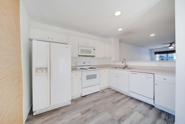 kitchen with sink, white appliances, light hardwood / wood-style flooring, ceiling fan, and white cabinetry