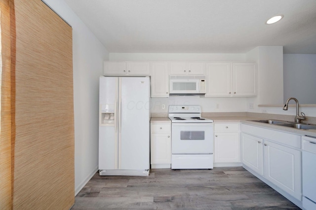 kitchen featuring white cabinetry, sink, white appliances, and light wood-type flooring