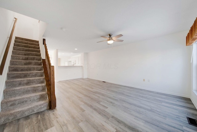 unfurnished living room with ceiling fan and light hardwood / wood-style flooring