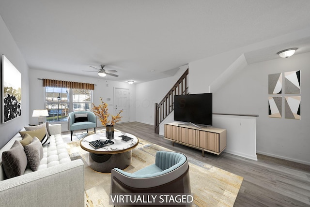 living room with ceiling fan and hardwood / wood-style floors