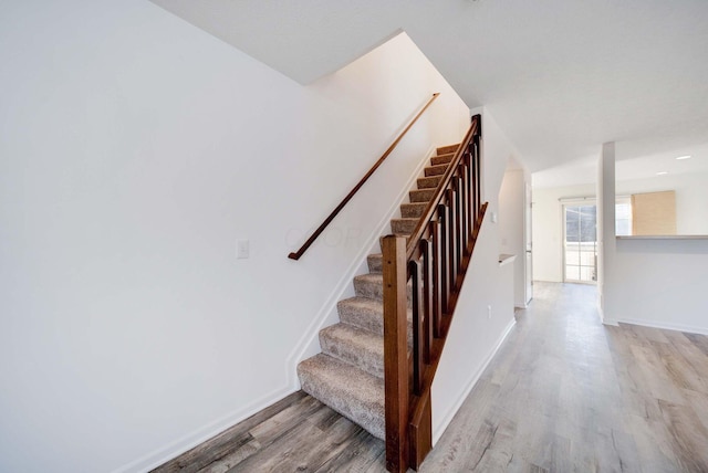 stairs with hardwood / wood-style flooring