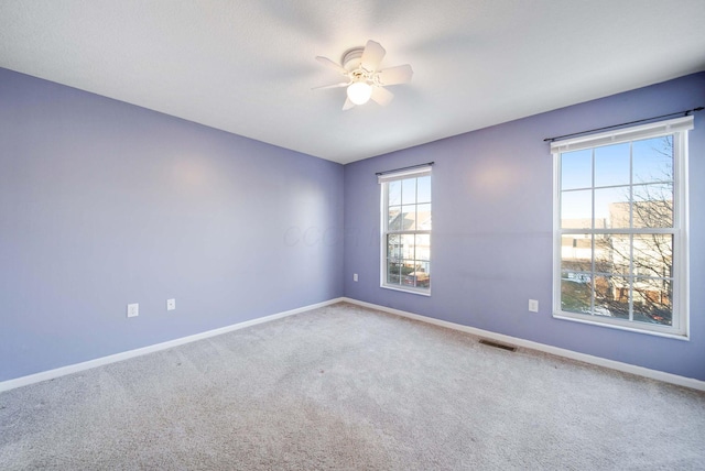 carpeted empty room with ceiling fan