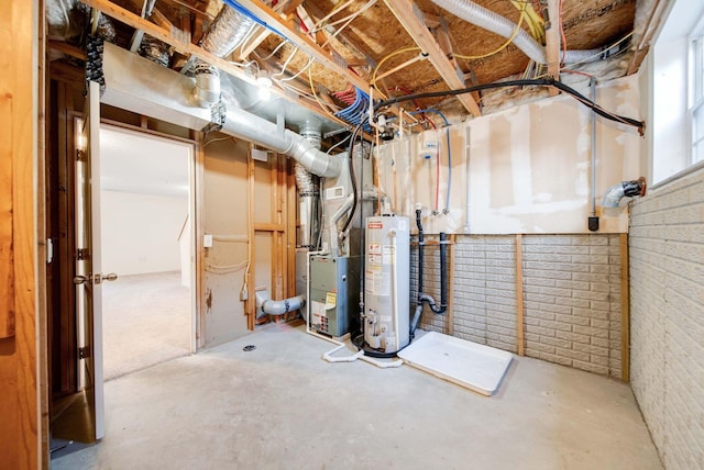 basement with heating unit, gas water heater, and brick wall