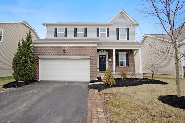 front of property featuring a garage, covered porch, and a front lawn