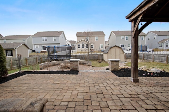 view of patio / terrace with a trampoline and a shed