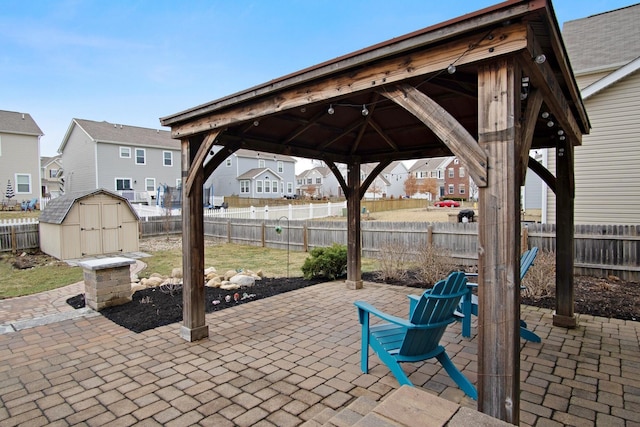 view of patio with a gazebo and a storage shed