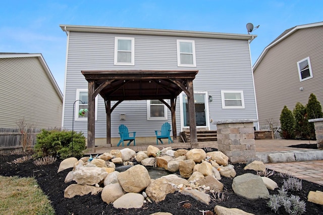 back of house with a gazebo and a patio