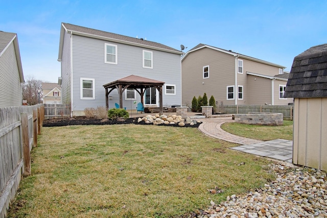 back of house with a gazebo and a yard