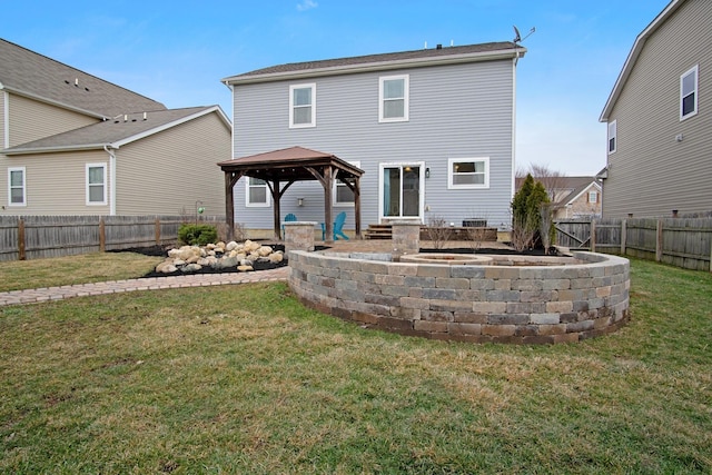 back of house with a gazebo and a lawn