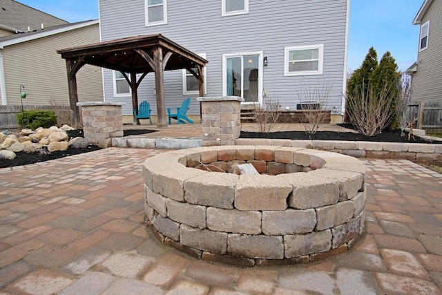 view of patio featuring a fire pit and a gazebo