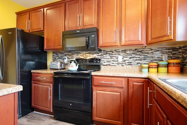 kitchen featuring tasteful backsplash, sink, and black appliances