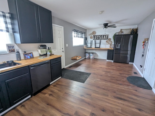 kitchen with fridge with ice dispenser, dishwasher, butcher block countertops, dark wood-type flooring, and ceiling fan