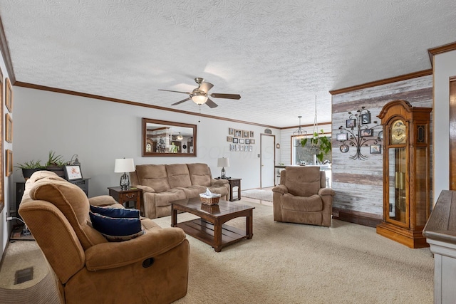 carpeted living room with crown molding, ceiling fan, and a textured ceiling