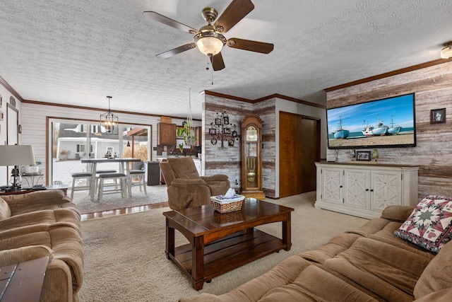 carpeted living room featuring ornamental molding, wooden walls, and a textured ceiling