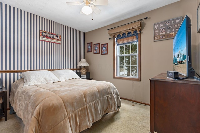 carpeted bedroom with a textured ceiling and ceiling fan