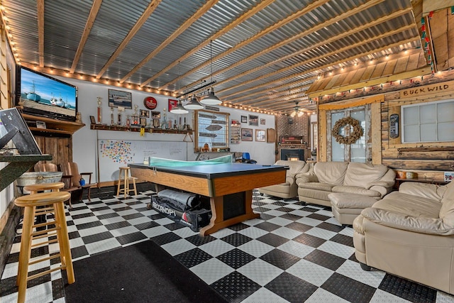 playroom with a brick fireplace, pool table, ceiling fan, and indoor bar