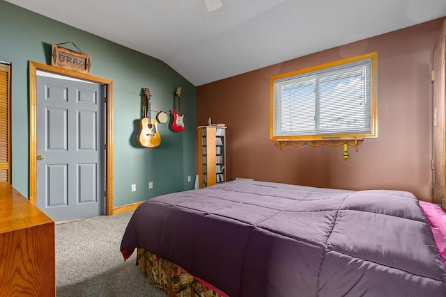 bedroom featuring lofted ceiling and carpet floors