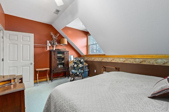 bedroom featuring ceiling fan, lofted ceiling, and light carpet