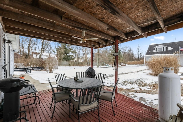 snow covered deck with ceiling fan and grilling area