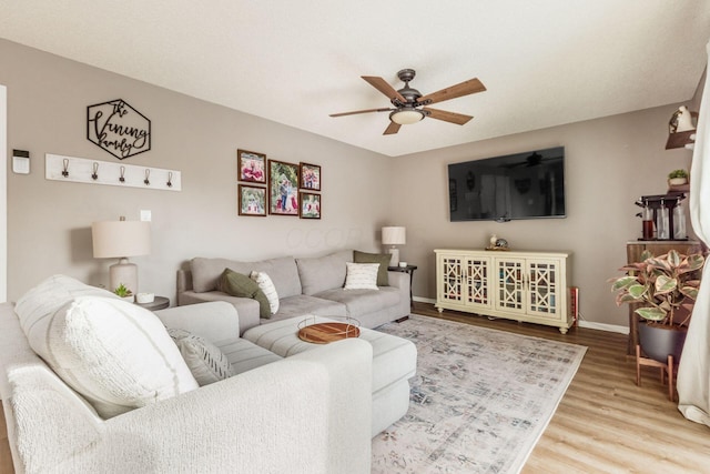 living room with hardwood / wood-style floors and ceiling fan