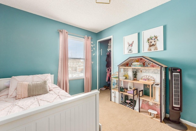 carpeted bedroom featuring a textured ceiling