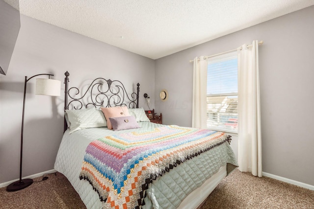 bedroom with carpet floors and a textured ceiling