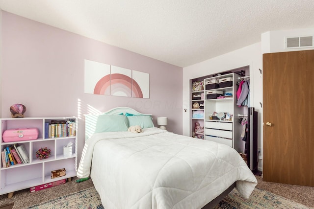 carpeted bedroom with a textured ceiling and a closet