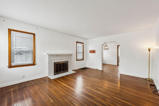 unfurnished living room with dark hardwood / wood-style flooring and a fireplace