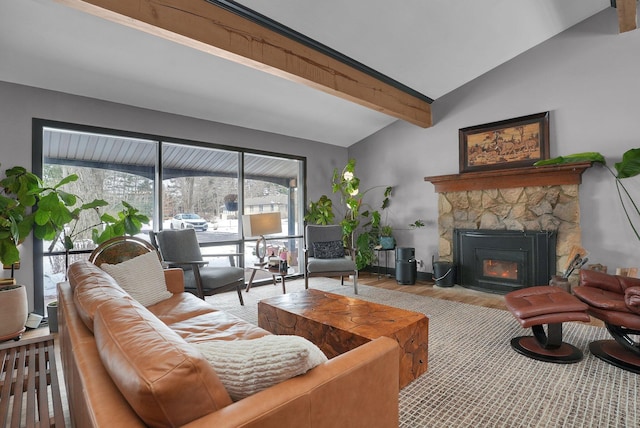 living room featuring light wood-style flooring, a stone fireplace, and lofted ceiling with beams