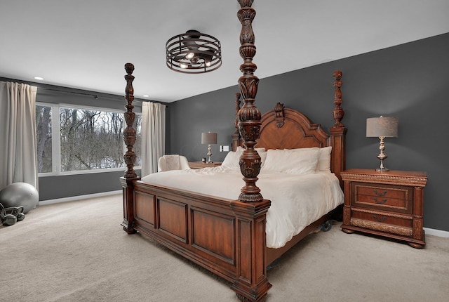 bedroom featuring baseboards and light colored carpet